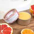 Natural grapefruit cuticle balm pots in compostable bright and dark packaging