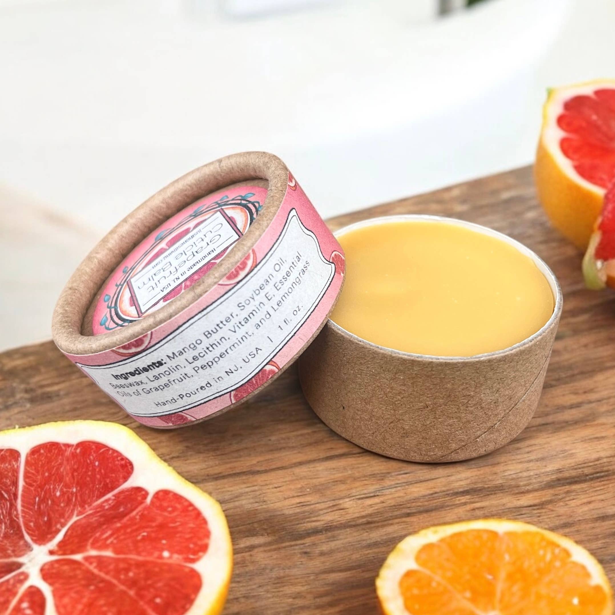 Natural grapefruit cuticle balm pots in compostable bright and dark packaging